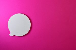 A speech bubble on a pink background.